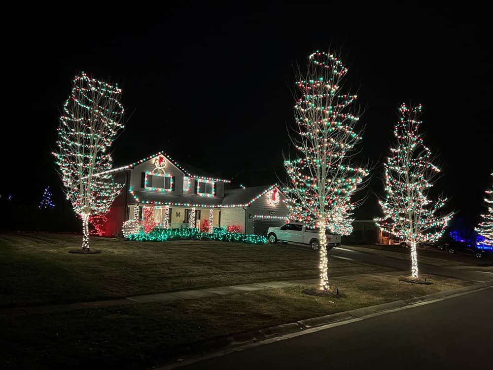 Christmas lights glowing beautifully on a home at night